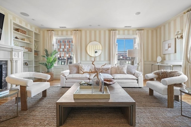 living room with dark wood-type flooring, a high end fireplace, crown molding, and built in features