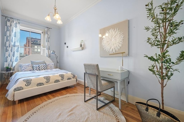 bedroom with light hardwood / wood-style flooring, ornamental molding, and a chandelier