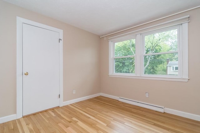 34 Brooks Rd, Wayland, MA 01778 - unfurnished room with a baseboard radiator, healthy amount of natural light, light wood-type flooring, and baseboards