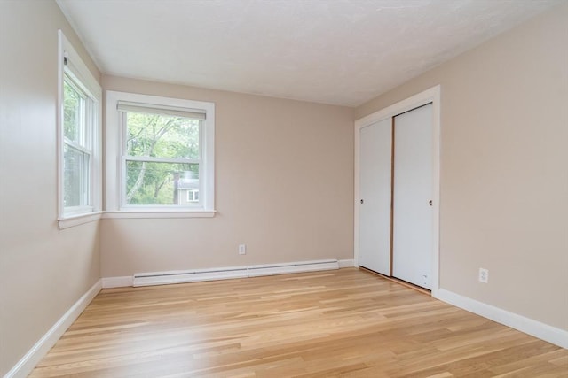 34 Brooks Rd, Wayland, MA 01778 - unfurnished bedroom with a baseboard radiator, light wood-style flooring, baseboards, and a closet