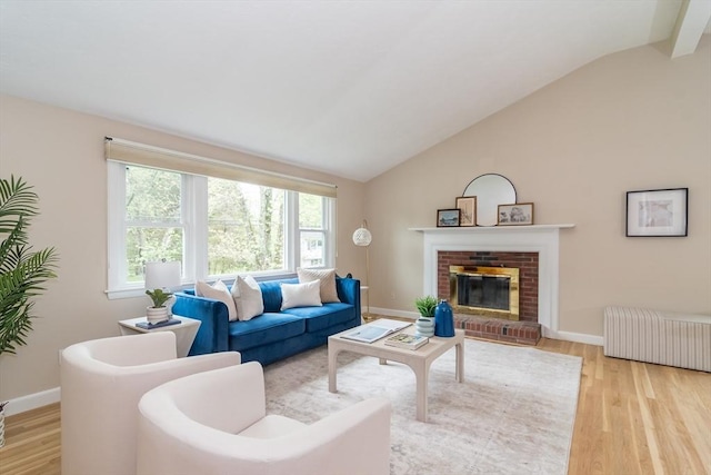 34 Brooks Rd, Wayland, MA 01778 - living area featuring lofted ceiling, wood finished floors, a brick fireplace, and baseboards