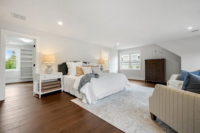 bedroom featuring dark wood-type flooring, multiple windows, visible vents, and recessed lighting