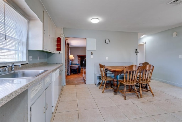 dining area with light tile patterned floors, visible vents, and baseboards