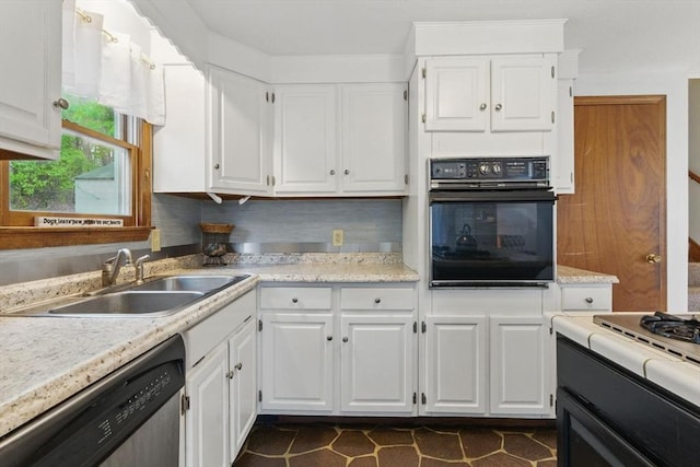 kitchen with light countertops, a sink, black oven, white cabinets, and dishwasher