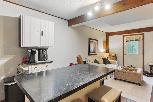 dining area with a textured ceiling and light wood-style flooring
