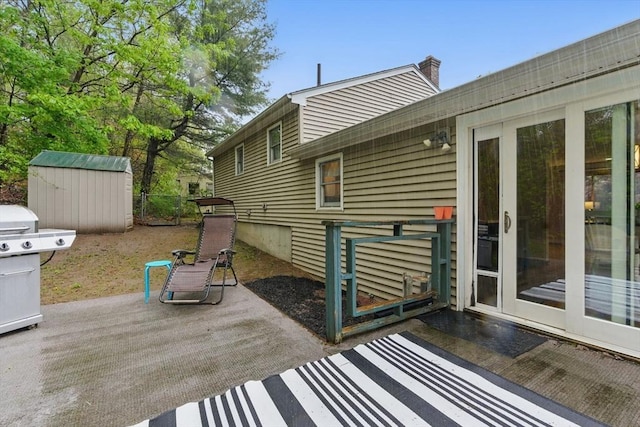exterior space featuring grilling area, an outdoor structure, and a shed
