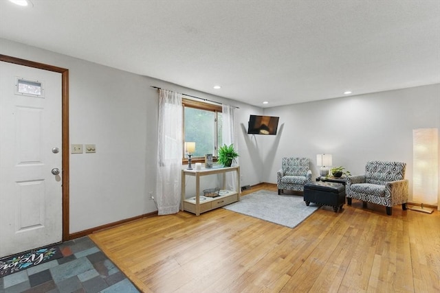 foyer entrance with baseboards, recessed lighting, and hardwood / wood-style flooring