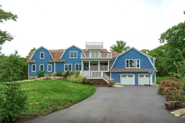 247 Forest Ave, Cohasset, MA 02025 - shingle-style home featuring a gambrel roof, an attached garage, driveway, covered porch, and a front yard