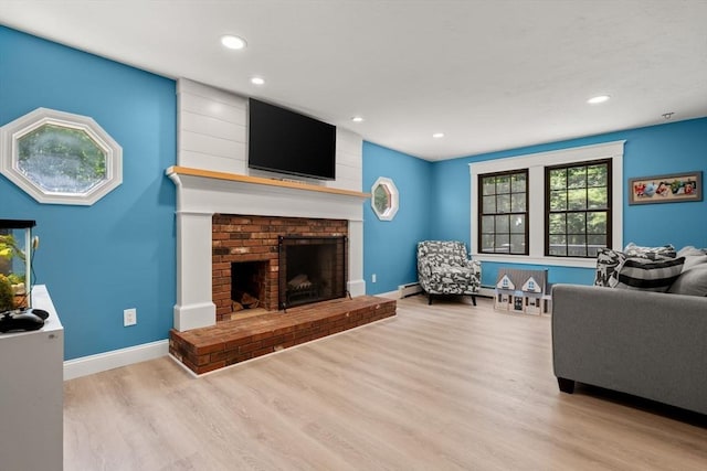 38 Manchaug Rd, Sutton, MA 01590 - living room with wood finished floors, a brick fireplace, and recessed lighting