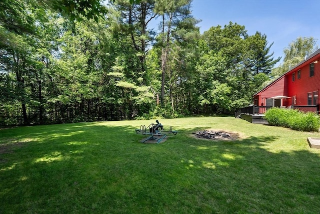 38 Manchaug Rd, Sutton, MA 01590 - view of green lawn with an outdoor fire pit and a deck