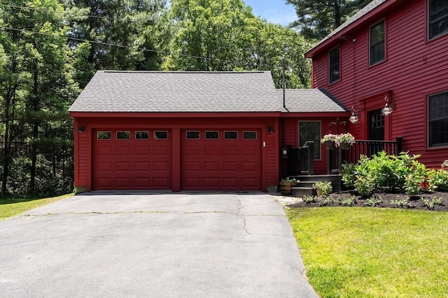 38 Manchaug Rd, Sutton, MA 01590 - view of front of house with an attached garage, asphalt driveway, roof with shingles, and a front lawn