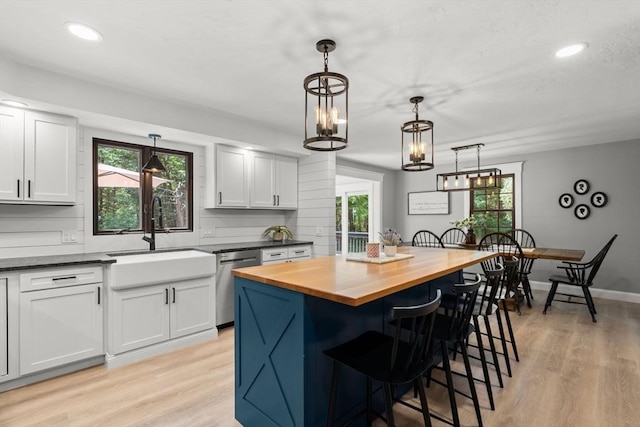 38 Manchaug Rd, Sutton, MA 01590 - kitchen featuring butcher block counters, dishwasher, a breakfast bar, light wood-type flooring, and recessed lighting