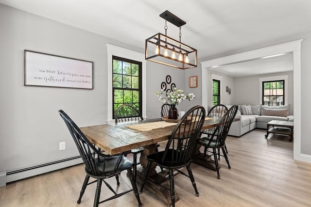 38 Manchaug Rd, Sutton, MA 01590 - dining room with baseboard heating, light wood-type flooring, plenty of natural light, and a chandelier