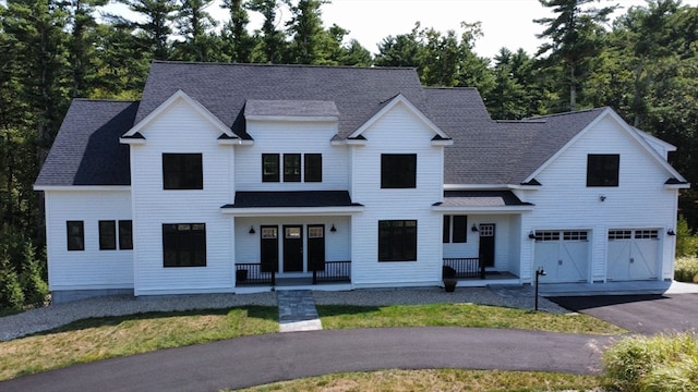 modern inspired farmhouse featuring a garage and a front lawn