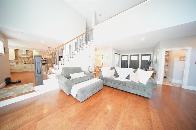 114 Country Club Way, Kingston, MA 02364 - living area with a towering ceiling, baseboards, stairway, and wood finished floors