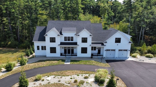 modern inspired farmhouse featuring a garage and a front lawn