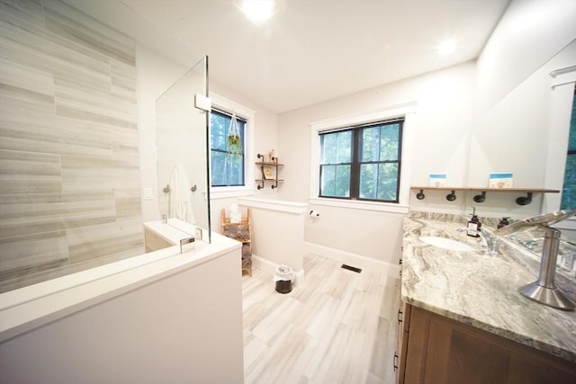 114 Country Club Way, Kingston, MA 02364 - bathroom with wood finished floors, vanity, baseboards, and walk in shower