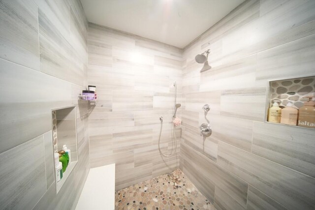 bathroom with a tile shower