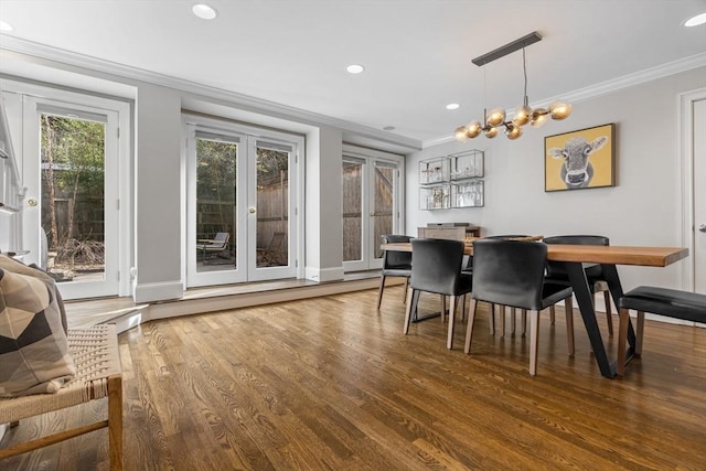 dining room featuring baseboards, ornamental molding, recessed lighting, wood finished floors, and a notable chandelier