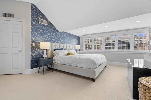 carpeted bedroom with visible vents, wallpapered walls, an accent wall, and baseboards