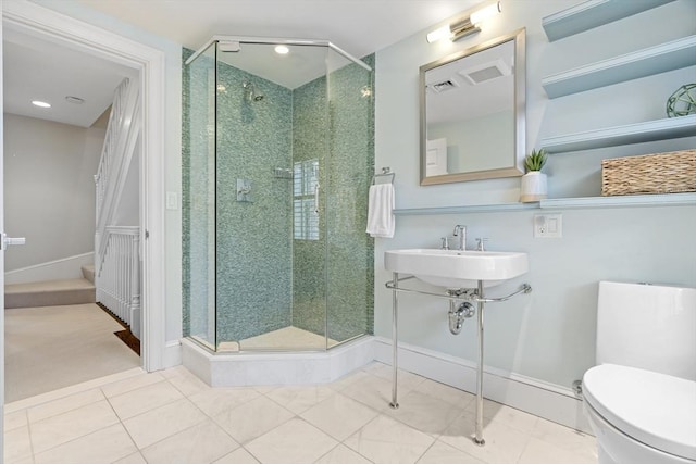 full bathroom with tile patterned flooring, a shower stall, toilet, and a sink