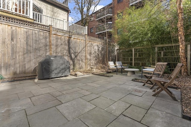 view of patio / terrace with a fenced backyard and a grill