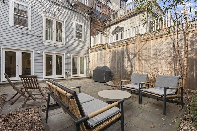 view of patio / terrace featuring french doors, grilling area, and fence