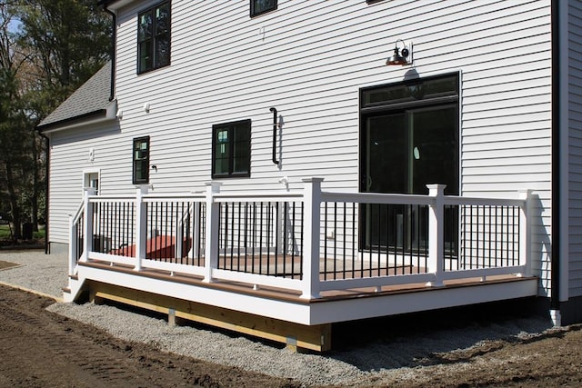 rear view of house featuring a deck