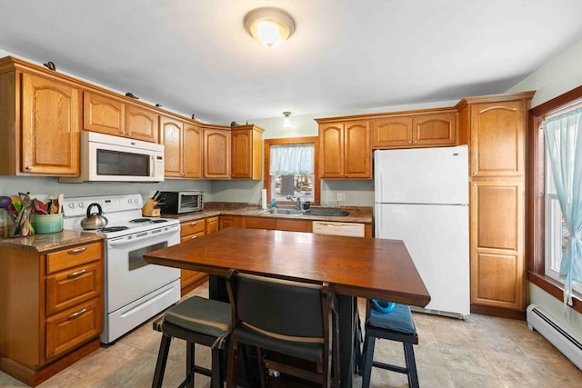 kitchen featuring white appliances, a toaster, a sink, brown cabinets, and baseboard heating