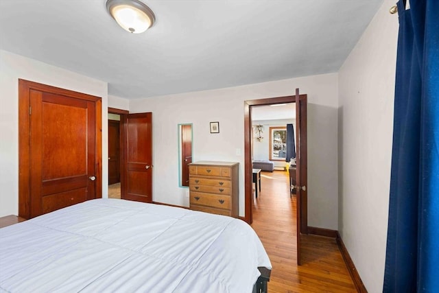 bedroom with wood finished floors and baseboards