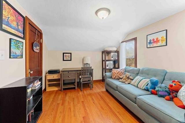 living area featuring light wood finished floors, baseboards, and lofted ceiling