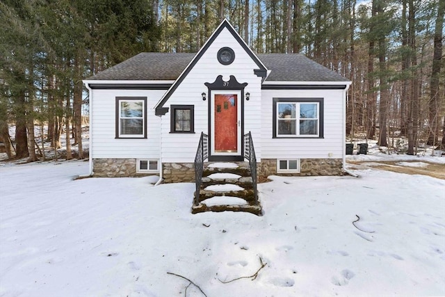 view of front of property featuring entry steps and a shingled roof