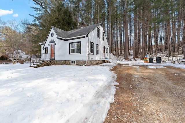 snow covered property featuring a chimney