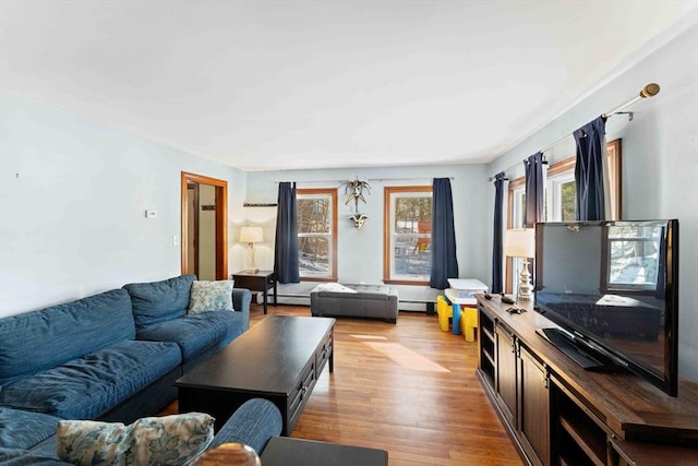 living room featuring baseboard heating and light wood-style flooring