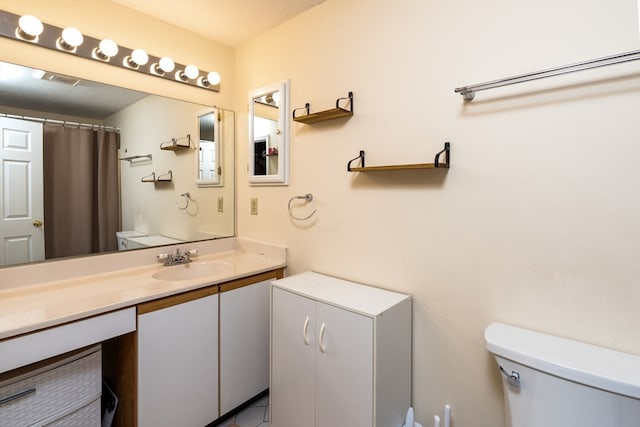 bathroom with vanity, a shower with curtain, and toilet