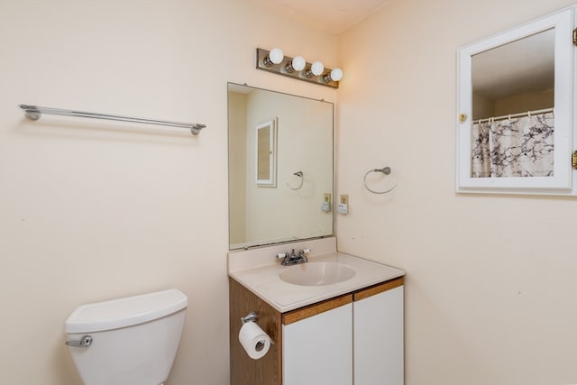 bathroom featuring vanity and toilet