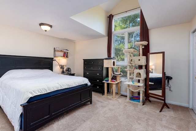 carpeted bedroom featuring lofted ceiling