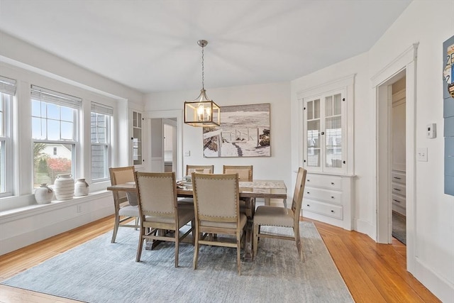 dining room featuring light wood-style flooring and a chandelier