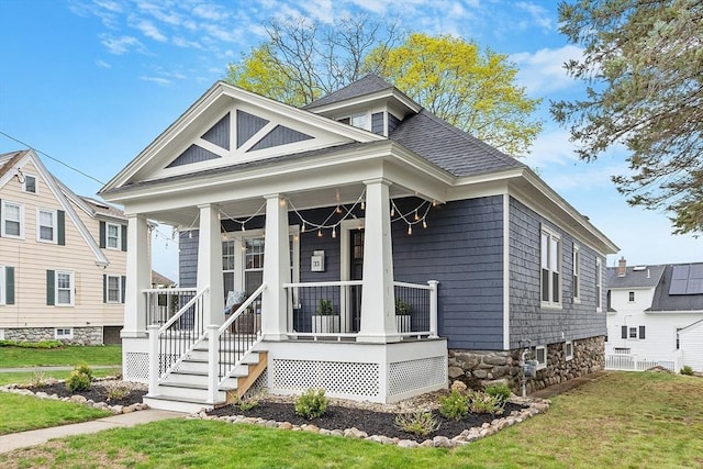 view of front of house with a porch and a front yard