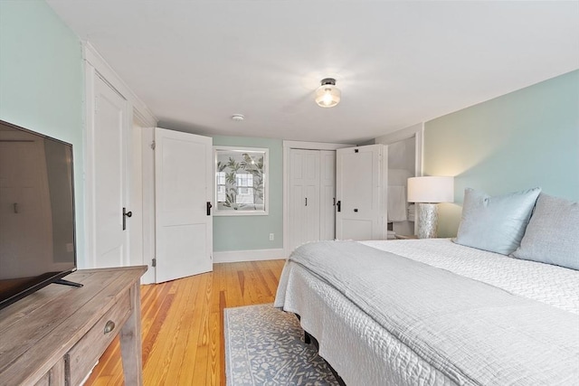 bedroom with a closet, baseboards, and light wood-style floors