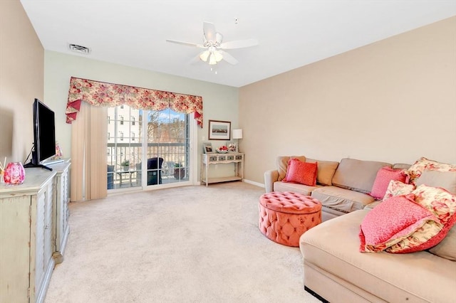 living area featuring carpet flooring, a ceiling fan, and visible vents