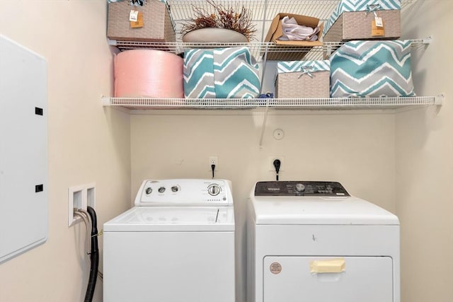 washroom with washing machine and clothes dryer and laundry area