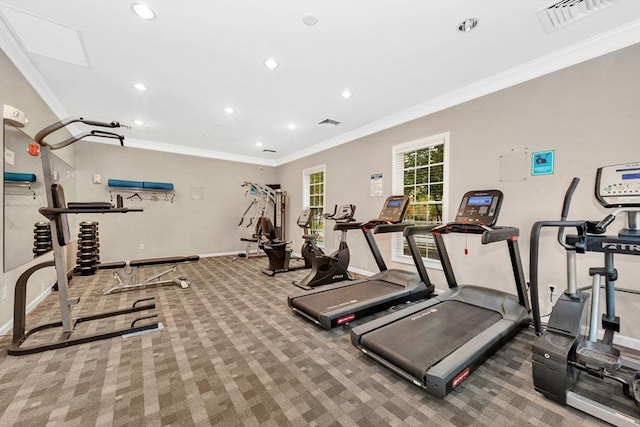 gym with carpet flooring, visible vents, baseboards, and ornamental molding