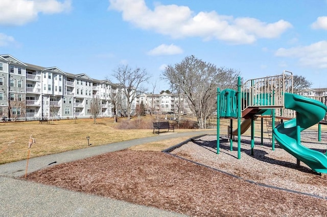 community jungle gym featuring a lawn