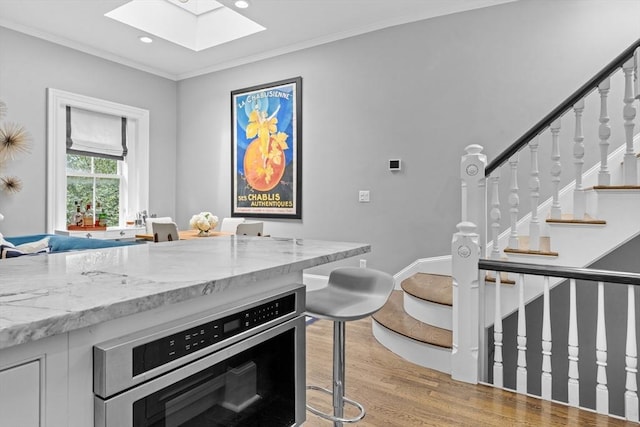 19 Greenwich Park Unit 5, Boston, MA 02118 - kitchen featuring a skylight, light wood-type flooring, recessed lighting, oven, and crown molding