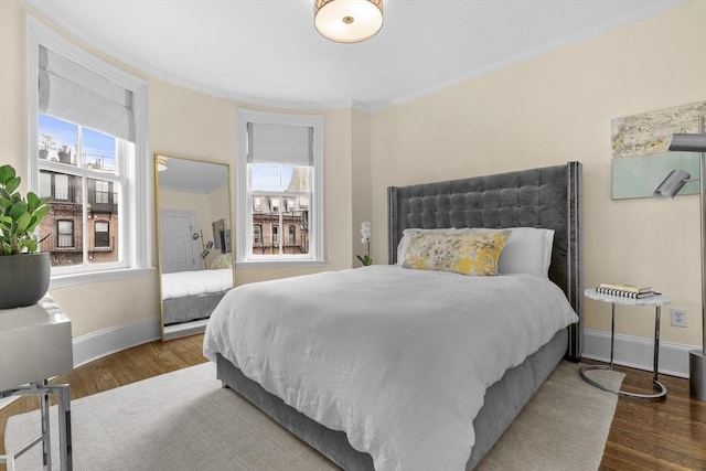 19 Greenwich Park Unit 5, Boston, MA 02118 - bedroom featuring multiple windows, wood finished floors, and crown molding