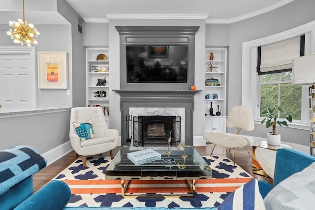 19 Greenwich Park Unit 5, Boston, MA 02118 - living room with wood finished floors, ornamental molding, built in features, a premium fireplace, and a chandelier