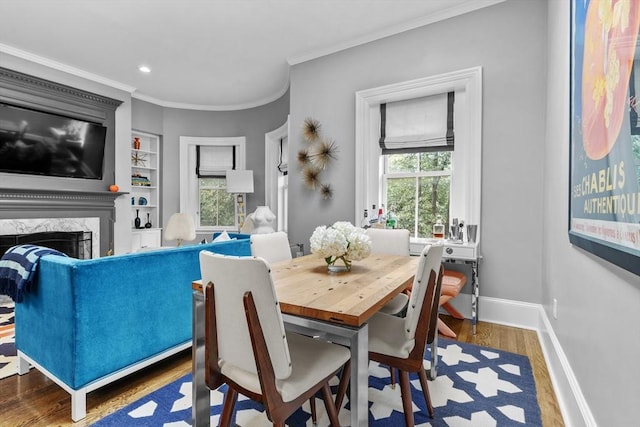 19 Greenwich Park Unit 5, Boston, MA 02118 - dining space featuring ornamental molding, wood finished floors, built in shelves, a high end fireplace, and recessed lighting