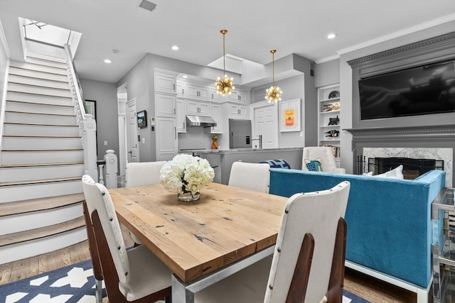 19 Greenwich Park Unit 5, Boston, MA 02118 - dining area with stairway, recessed lighting, wood finished floors, a fireplace, and crown molding
