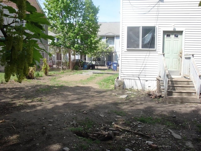 exterior space featuring entry steps and fence
